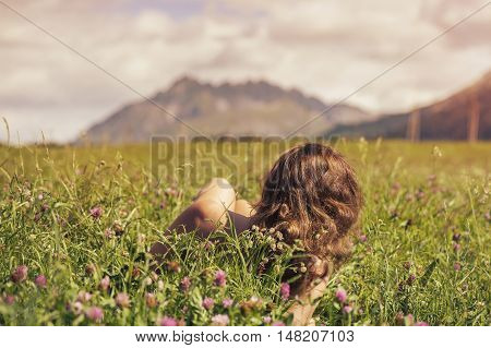 Naked female in a field at sunset