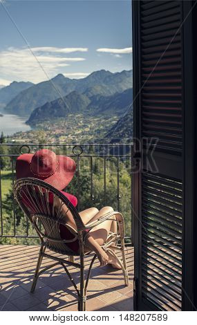 woman sitting on a chair on the balcony