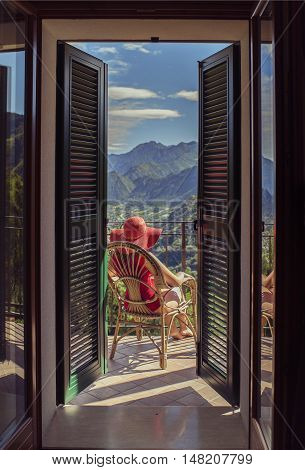 woman sitting on a chair on the balcony