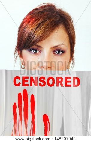 screen that covering part of woman face which represents censorship of statements