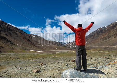 Traveler enjoying the view of Himalayan mountain landscape in Ladakh, Leh, India.