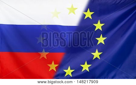 Russia and European Union relations concept with diagonally merged real fabric flags