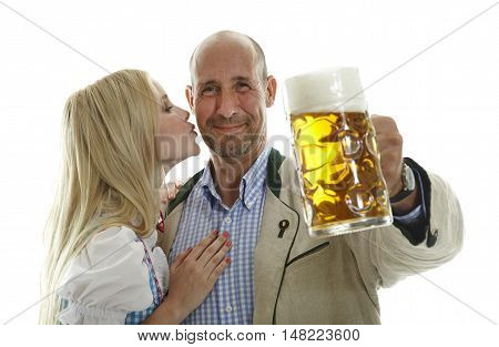 Woman in Dirndl and Man in traditional bavarian Oktoberfest leather Cloting cheering with a beer mug