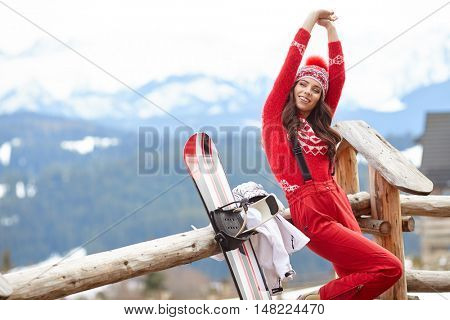 winter, leisure, sport and people concept - happy young woman in ski cothes outdoors