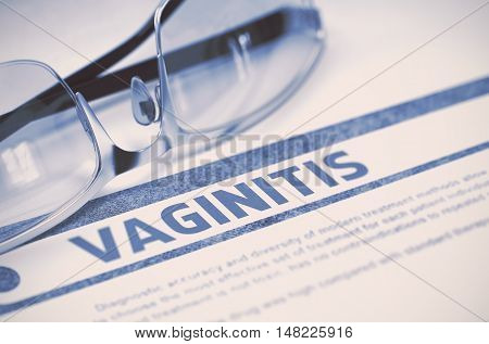 Vaginitis - Medical Concept with Blurred Text and Pair of Spectacles on Blue Background. Selective Focus. 3D Rendering.