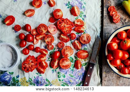 Tomato on wooden table. Freshly Picked red Tomatoes. Variation of tomatoes on wooden surface. Vegetables in the section. Harvesting. Healthy food from the garden.
