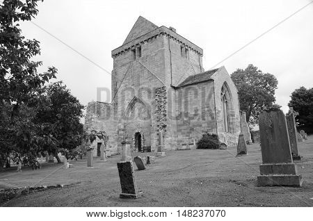 A view across a graveyard to Crichton collegiate church