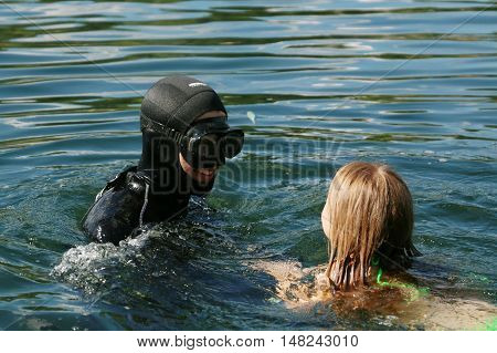 Diver plays with a child in the water