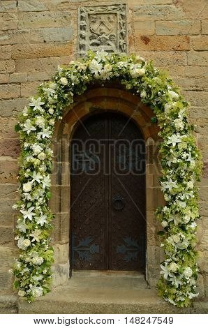 A floral garland around a door at Crichton collegiate church