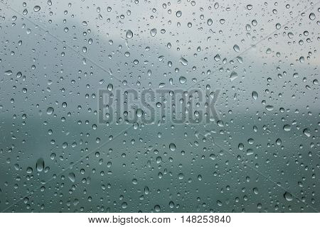 Natural blue water drop on window background