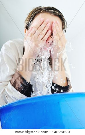 bautiful young woman wash face with clean water isolated on white in studio