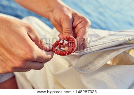 User knitting knots. Bowline knot. Process of tying Bowline process is a top view on the sail.