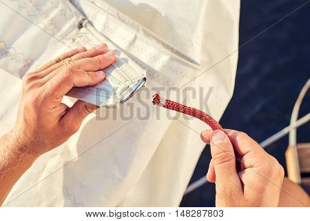 User knitting knots. Bowline knot. Process of tying Bowline process is a top view on the sail.