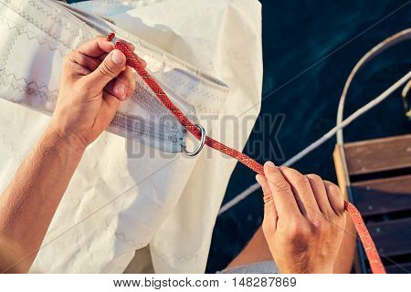 User knitting knots. Bowline knot. Process of tying Bowline process is a top view on the sail.