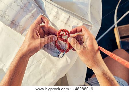 User knitting knots. Bowline knot. Process of tying Bowline process is a top view on the sail.