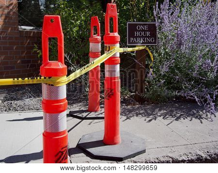 Pylons and danger tape mark off a closed walkway.