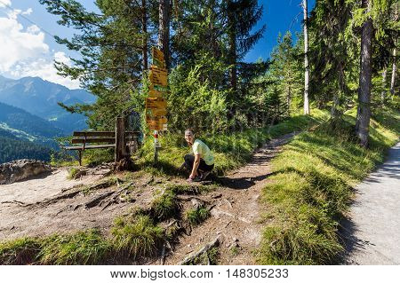 Girl In Sport Clothes Finding A Mushroom In The Forest