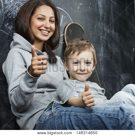 young hipster teenage girl sitting with her brother in classroom multinational, lifestyle people concept