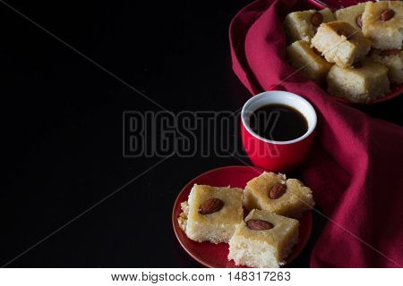 Basbousa and Coffee with Dark Background Horizontal with Copy Space from Above