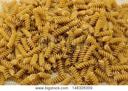Pile of dry uncooked whole wheat rotini pasta