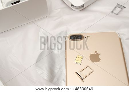PARIS FRANCE - SEP 16 2016: New Apple iPhone 7 Plus unboxed in the first day of sales - inserting SIM card in new phone. New Apple iPhone acclaims to become the most popular smart phone in the world in 2016