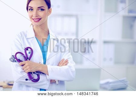Portrait of happy successful young female doctor holding a stet