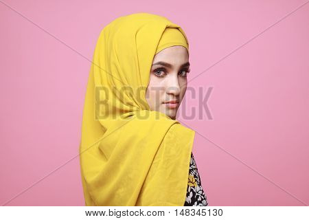 muslimah model in fashionable dress isolated in pink background