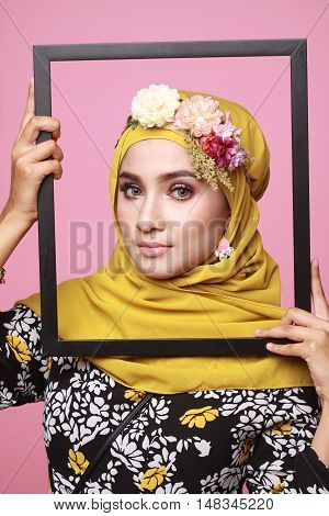 muslimah model in fashionable dress isolated in pink background