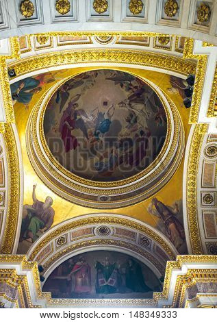 SAINT PETERSBURG RUSSIA - APRIL 25 2015: The painted semi-dome of St Isaac's Cathedral surrounded by gilt carved patterns on April 25 in Saint Petersburg.