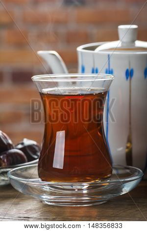 Tea with dates on wooden table. Selective focus