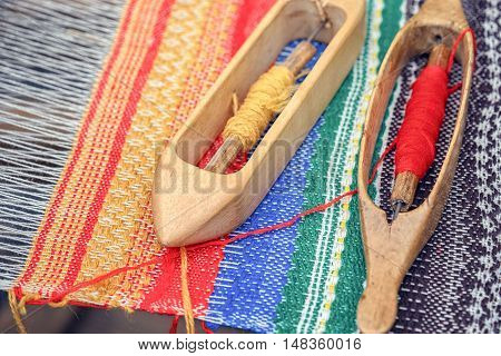 Weaving loom and shuttle on the warp.