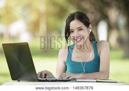 Portrait of a asian young business woman using laptop at office