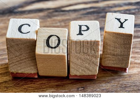 Copy Stamp on Woden Background. Copy Word Written in Wood Blocks.