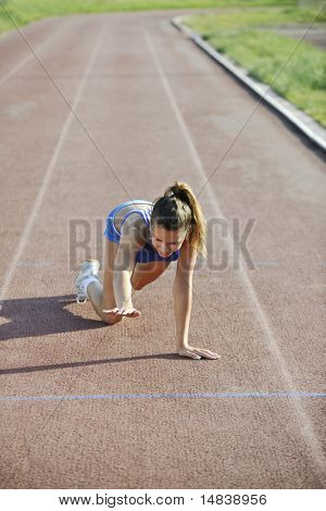 young woman finally passing finis line at athletics running race track