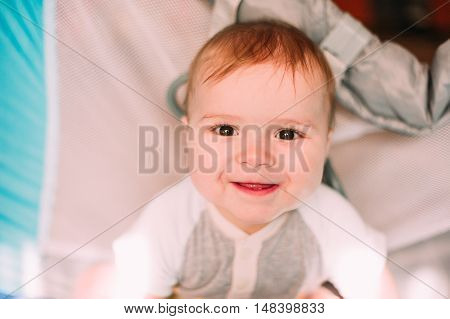 Cute Little Baby Boy Playing In Colorful Playpen, Indoors. Beautiful Child Having Fun At Nursery.