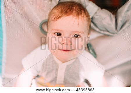 Cute Little Baby Boy Playing In Colorful Playpen, Indoors. Beautiful Child Having Fun At Nursery.