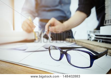 Engineer Teamwork Sketching A Building Project.