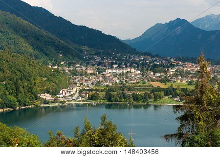 Aerial view of the small town of Levico Terme with the lake and the mountains. Trentino Alto Adige Italy Europe