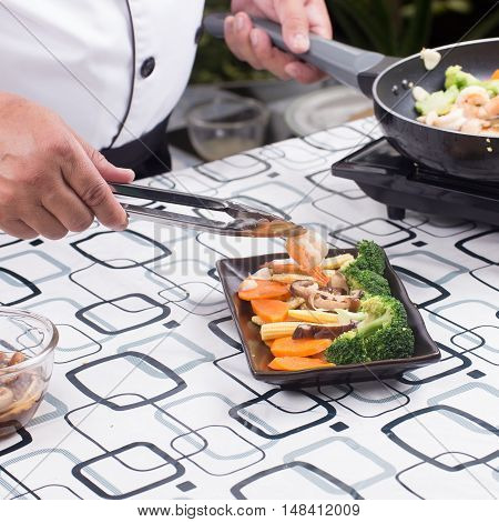 Chef decorated stir fry vegetables on plate / Stir fry Broccoli concept