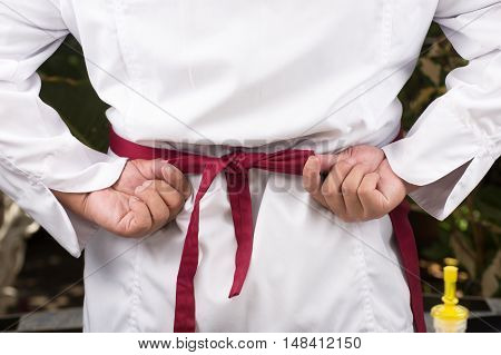 Chef dress up and tied aporn before cooking