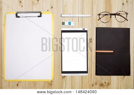 View from above of office supplies and technology divice on a wooden working table background. Hipster vintage retro style.