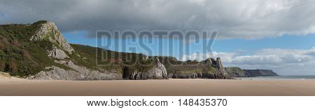 Panorama of the cliffs on Oxwich Bay and Nicolaston Burrows featuring the Great Tor on the Gower peninsular, South Wales.