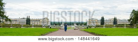 Panorama of the Palace and park ensemble Arkhangelskoye in Moscow with the walking woman