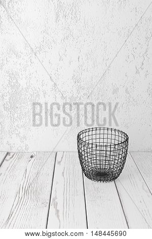 Vintage wire basket on white wooden rustic floor industrial wicker storage bin