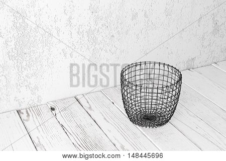Vintage wire basket on white wooden rustic floor industrial wicker storage bin