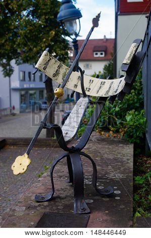a rustical sun clock outside in a park. Sundial Germany