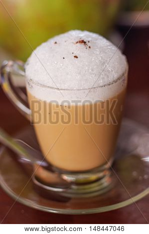 A cup of cappuccino on wooden table