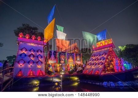 KOLKATA INDIA - OCTOBER 21 2015 : Beautiful exterior of decorated Durga Puja pandal at night Howrah West Bengal India. Shot under colored lights. Durga Puja is biggest religious festival of Hinduism.