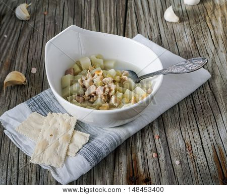 Rhode Island Clam Chowder Soup on Wood Background, selective focus.