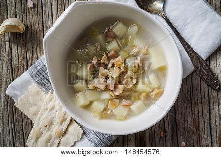 Rhode Island Clam Chowder Soup on Wood Background, top view, close-up.